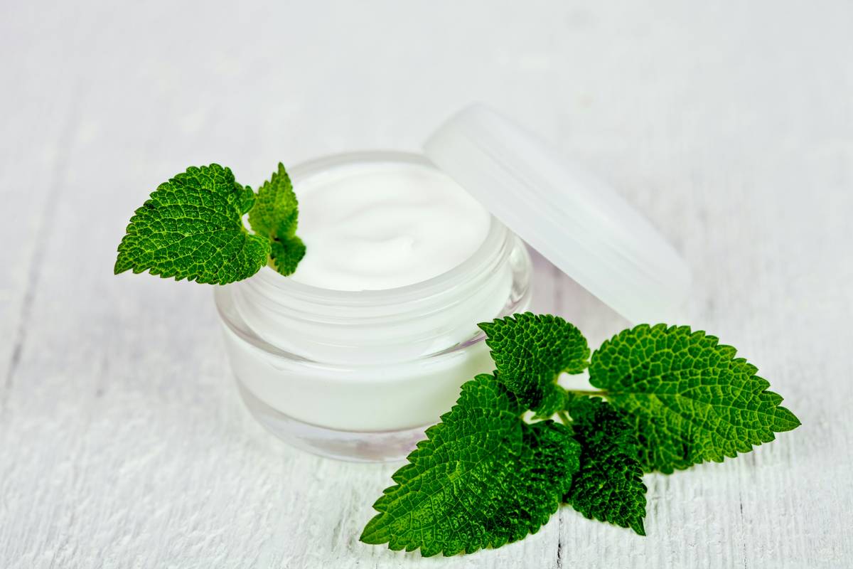 Close-up of Eco-Friendly Creams jar made from recycled glass with organic botanical labels