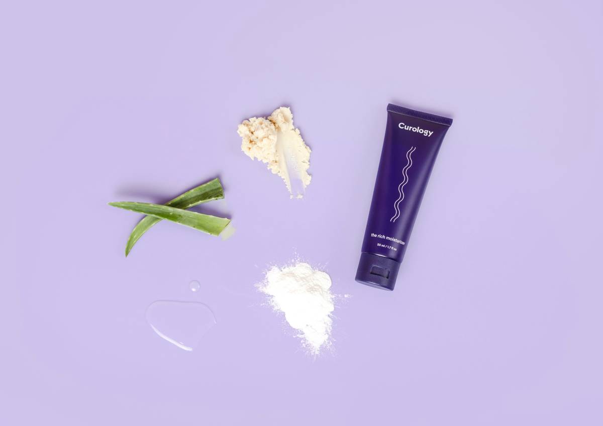 skincare product and ingredients on purple background